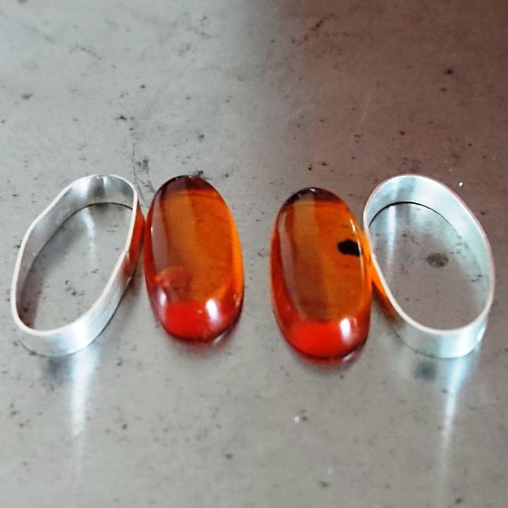 Handmade sterling silver bezel set amber cufflinks creating the bezel