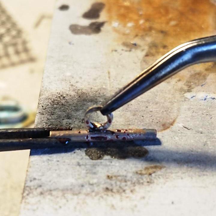 Handmade sterling silver bezel set amber cufflinks soldering the chain link on to the cufflink bar