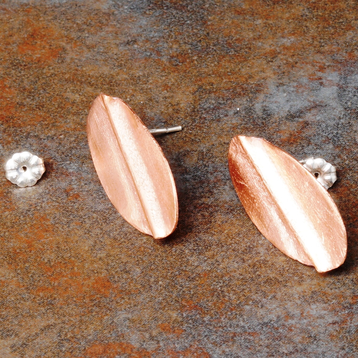Handmade oval copper fold formed stud earrings, with sterling silver posts and backs