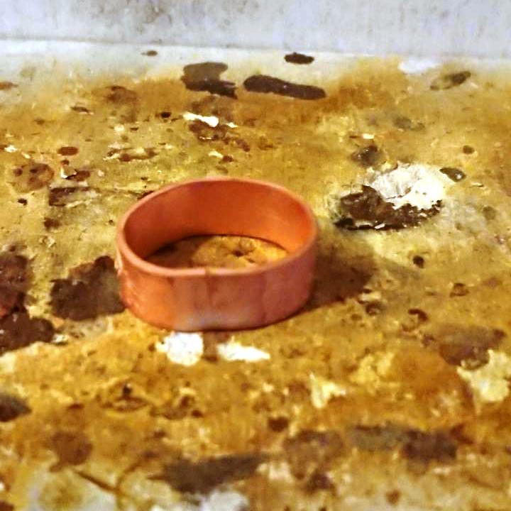 Handmade dandelion stamped copper ring after pickle