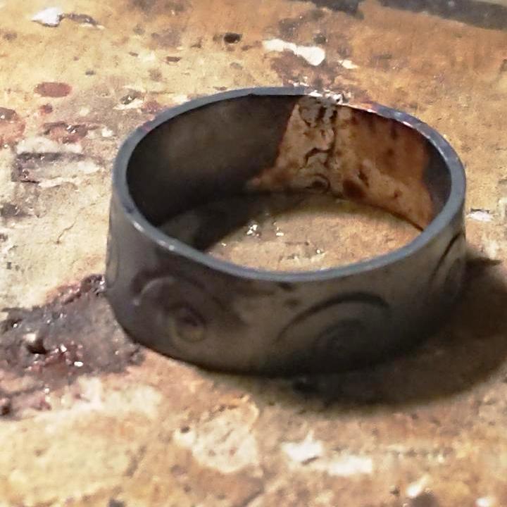 Handmade spiral stamped copper ring after soldering