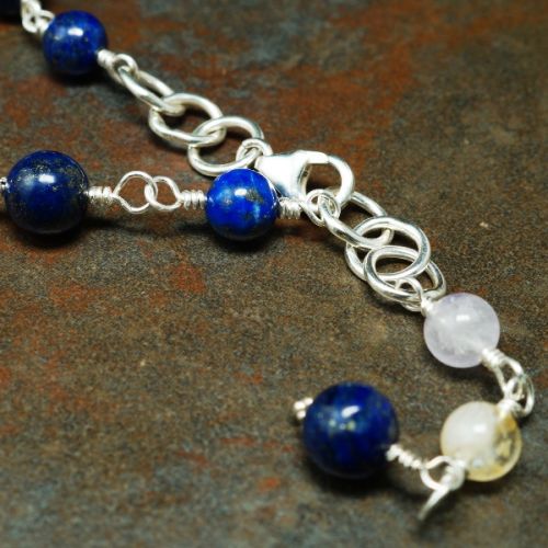 Discover the power of lapis lazuli, amethyst, rose quartz, and citrine in this bespoke handmade recycled sterling silver wire-wrapped choker.